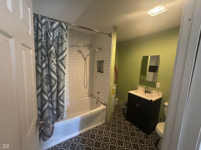 full bathroom with shower / bath combo, vanity, and toilet | Image 11