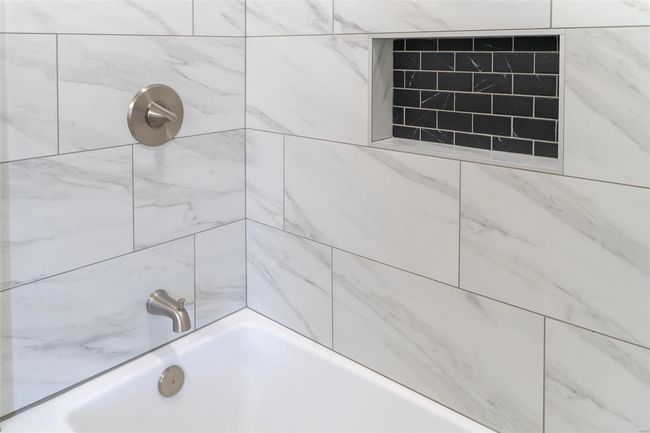 Bathroom featuring tiled shower / bath | Image 56