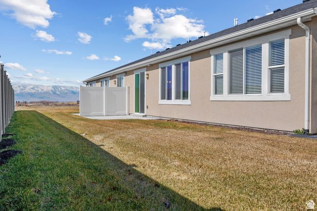Back of property featuring a lawn, fence, and stucco siding | Image 23