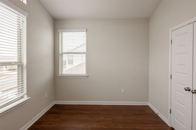 Spare room featuring baseboards and dark wood-style floors | Image 18