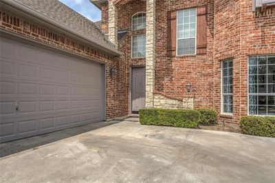 Doorway to property with a garage | Image 3