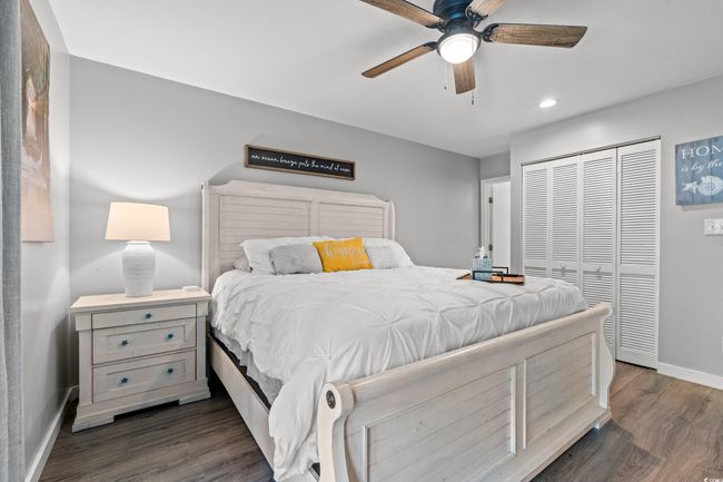 Bedroom with baseboards, a closet, dark wood-style floors, recessed lighting, and ceiling fan | Image 13