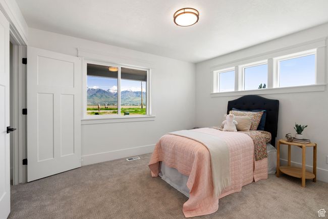 Bedroom featuring light carpet and baseboards | Image 12