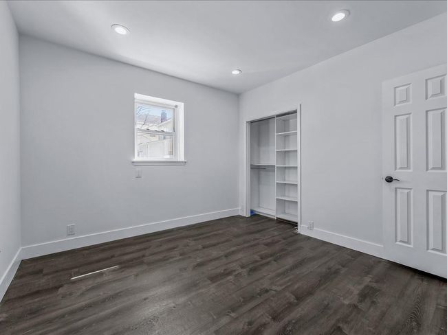 Unfurnished bedroom featuring dark wood finished floors, a closet, baseboards, and recessed lighting | Image 10
