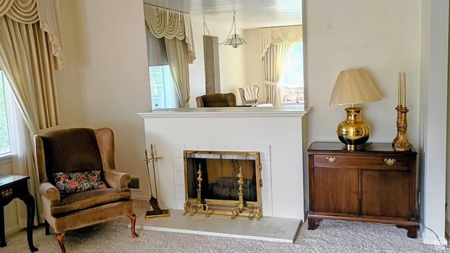 Living area with carpet floors and a tile fireplace | Image 7