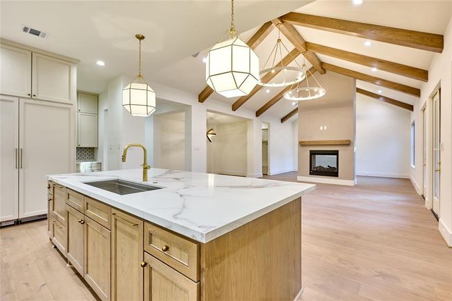 Open concept kitchen seamlessly flows into the living room, creating a spacious and connected environment. | Image 19