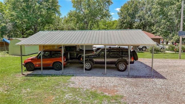 View of parking / parking lot featuring a carport | Image 42