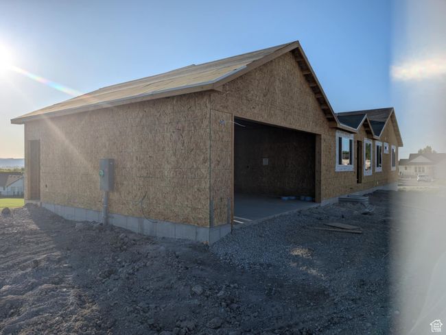 View of side of property featuring an attached garage | Image 5
