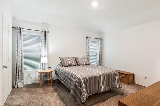 Welcome to the peaceful primary suite, offering space to relax and recharge after a long day. | Image 11