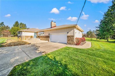 View of front facade featuring a 2-car attached garage and brand new front steps. | Image 2