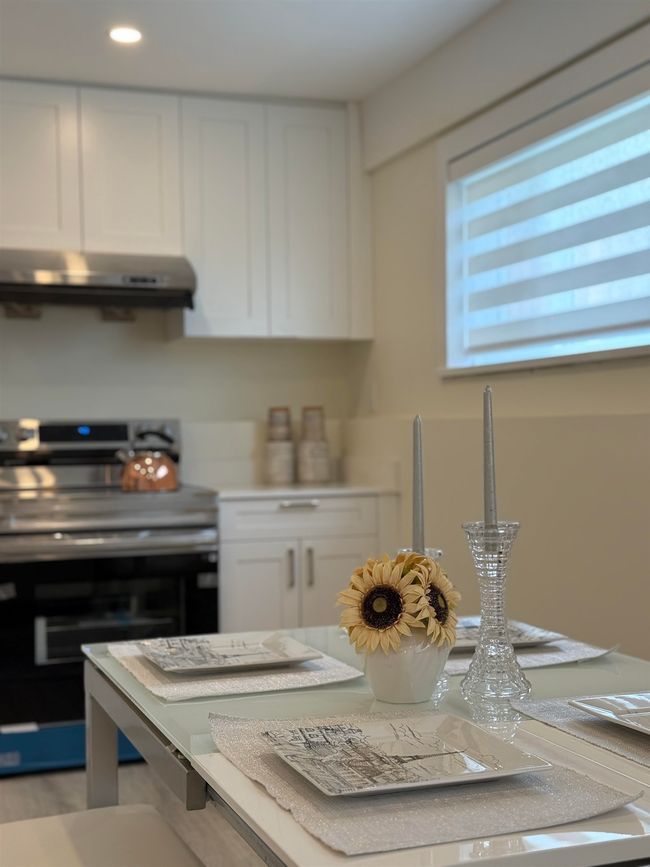 Kitchen featuring electric stove, white cabinets, light countertops, extractor fan, and recessed lighting | Image 20
