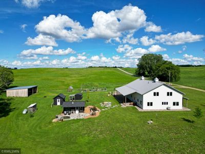 Spend your days outdoors and live off the land, complete with garden beds and a greenhouse. | Image 1