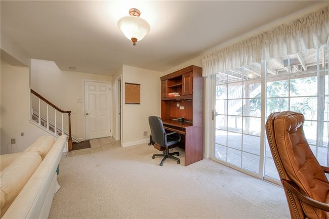 Game room with half bath and access to the backyard | Image 36