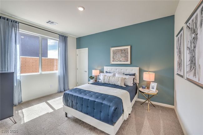 Bedroom on the first floor. Photo is representational only; actual home finishes may vary. Bedroom on the first floor with carpet floors and baseboards | Image 18