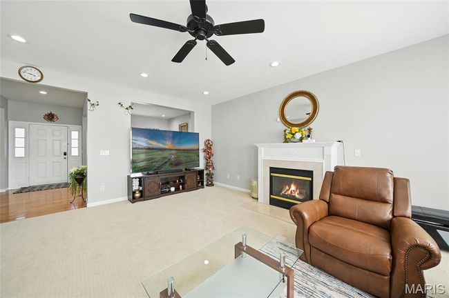 View of entry way from the family room, featuring fireplace and open floor plan | Image 6