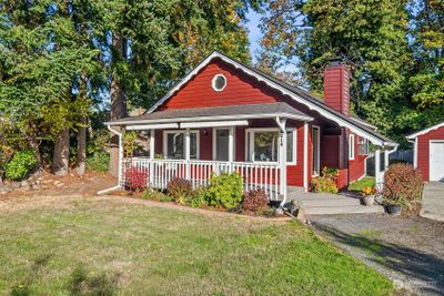 Fabulous wraparound porch is perfect for enjoying your morning coffee or relaxing with a glass of wine at the end of the day. | Image 2