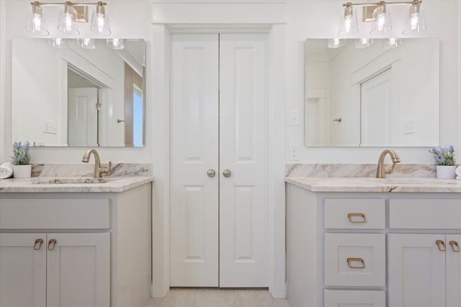 Bathroom with two vanities and a closet | Image 21