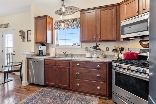 Beautiful choice of wood accents in this custom built home - stainless appliances too! | Image 19