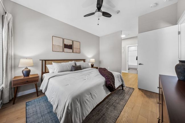 Bedroom with baseboards, light wood-style floors, and a ceiling fan | Image 18