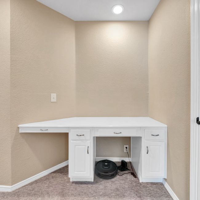 Built-in desk with light carpet, baseboards | Image 35