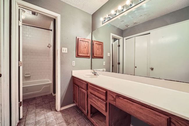 Bathroom with vanity, a textured ceiling, and shower combination | Image 21