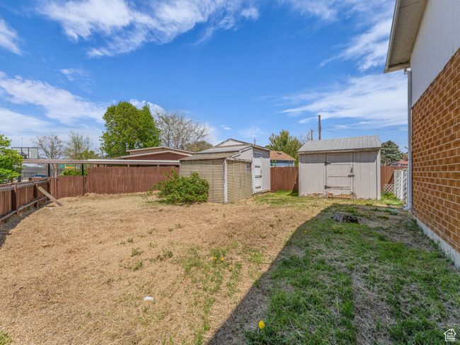 Side yard with outbuildings. | Image 25