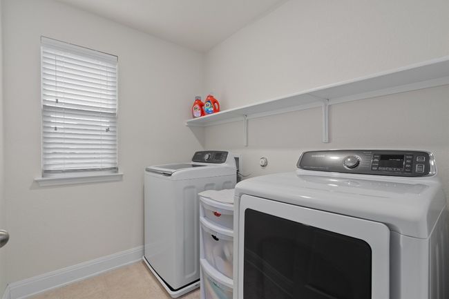 Washroom with washer and dryer and light tile patterned floors | Image 27