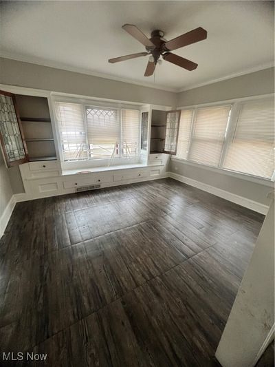 Dining room with ornamental molding, dark hardwood / wood-style floors, and ceiling fan | Image 3