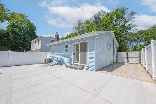 Rear view of property with a fenced backyard and a patio | Image 14