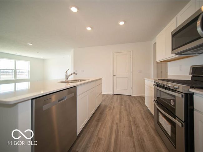 kitchen with a sink, white cabinetry, recessed lighting, appliances with stainless steel finishes, and light countertops | Image 21