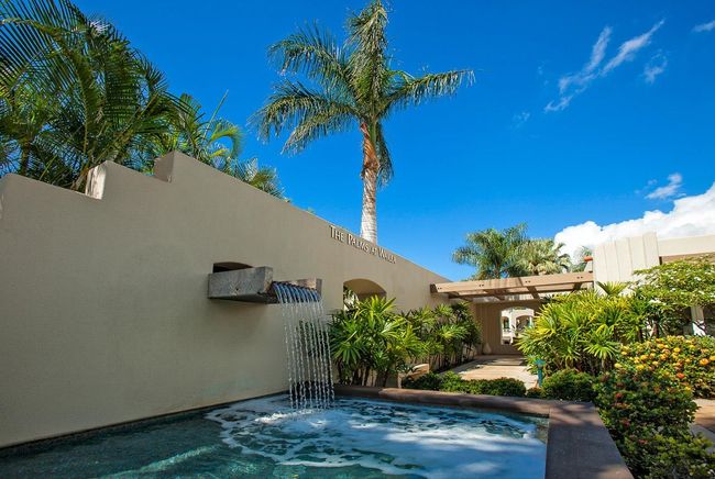 The Palms's main entrance has an eye-catching water feature in a garden setting | Image 38
