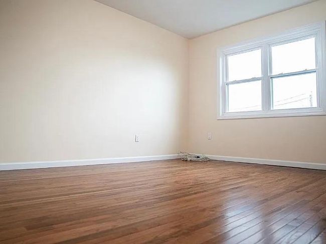 Spare room featuring wood finished floors and baseboards | Image 13