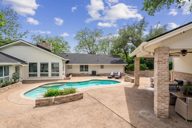 Pool area has a covered patio connected to the 3rd garage bay | Image 4
