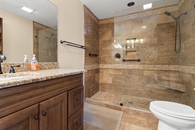Full bathroom with vanity, tiled shower, and toilet | Image 14