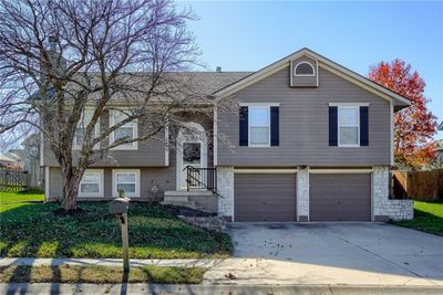 Split foyer home featuring a garage | Image 1