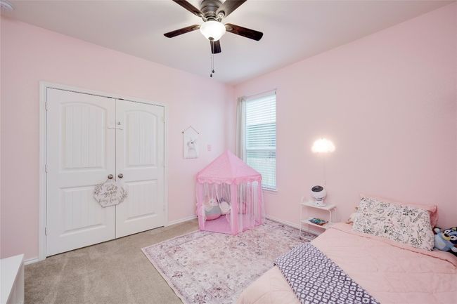 Carpeted bedroom with a closet and a ceiling fan | Image 22