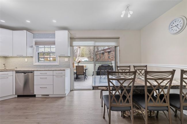 Dining area with light wood finished floors, wainscoting, visible vents, and recessed lighting | Image 12