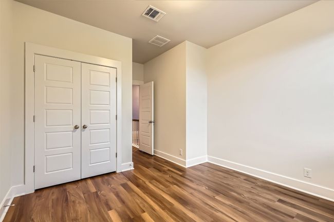 Unfurnished bedroom featuring dark wood-style flooring and a closet | Image 20