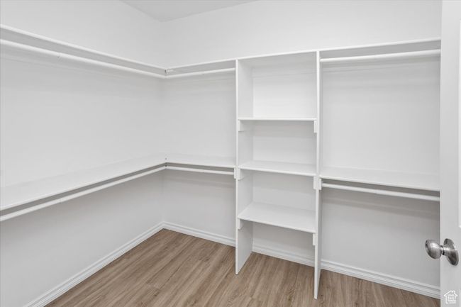 Spacious closet with wood finished floors | Image 21