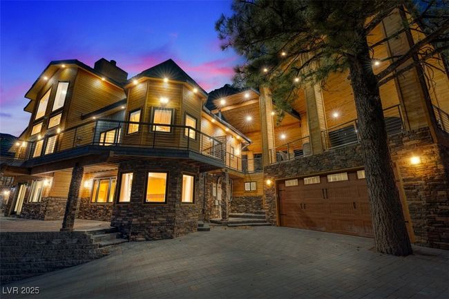 View of front of property featuring a garage, decorative driveway, and a balcony | Image 5