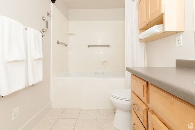 Full bath with tile patterned floors, vanity, and shower / bath combo | Image 13