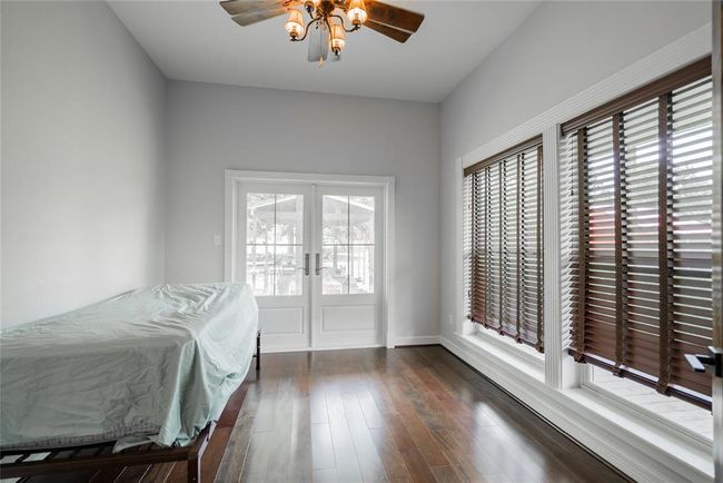 This is the third bedroom that is large as well, and has a french door leading out to the porch. Please notice again, the large windows and cherry wood floors. | Image 27