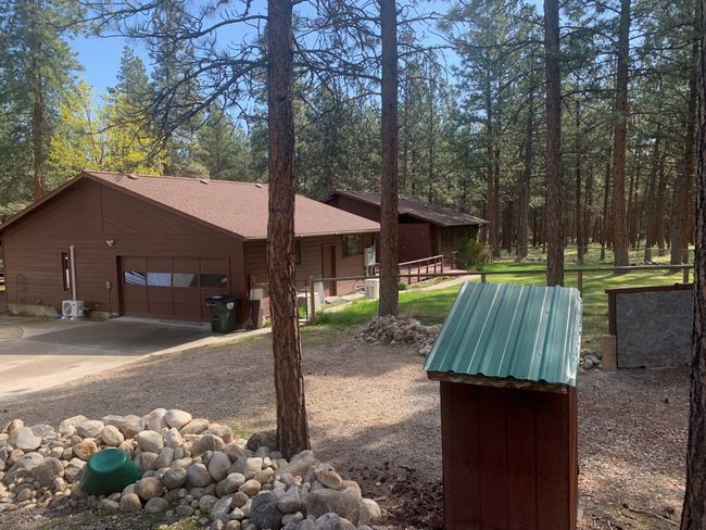 View of side of property with a shingled roof, driveway, and an attached garage | Image 60