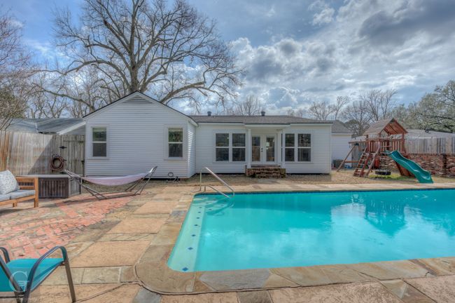 View of pool featuring french doors, a playground, entry steps, a patio area, and fence | Image 5