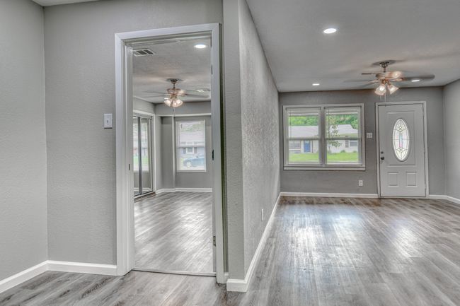 Foyer featuring a ceiling fan, a textured wall, wood finished floors, and recessed lighting | Image 5