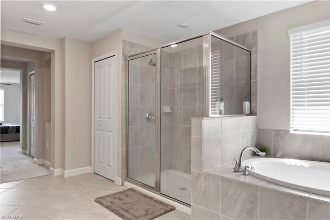 Full bathroom with a shower stall, tile patterned floors, visible vents, and a bath | Image 23