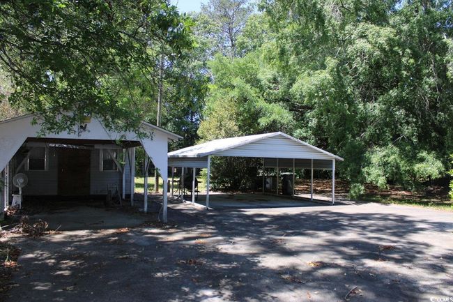 View of vehicle parking featuring driveway and a detached carport | Image 4