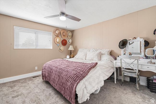 Carpeted bedroom with baseboards, visible vents, ceiling fan, and a textured ceiling | Image 31