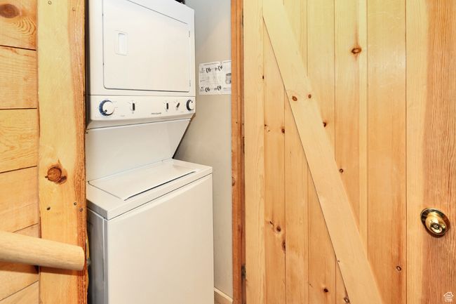 Laundry room featuring stacked washer and dryer | Image 54