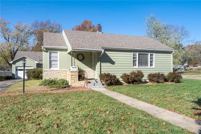 View of front of home featuring a garage, a front lawn, and an outbuilding | Image 3